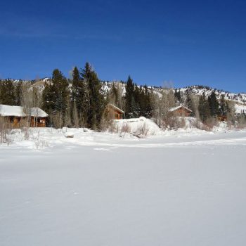 Cabins from frozen lake in winter